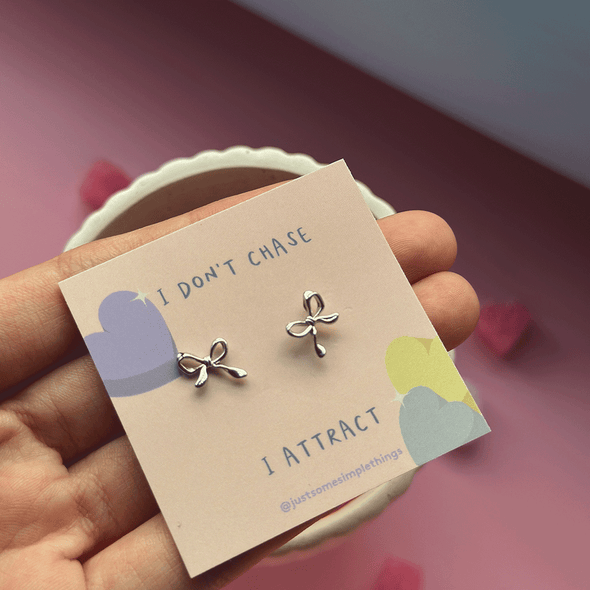 'I attract' mini ribbon ear studs